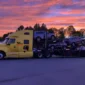 Xpert Trans car carrier truck loaded with multiple vehicles at sunrise, ready for cross-country auto transport